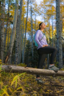 Hispanic woman hiking in woods