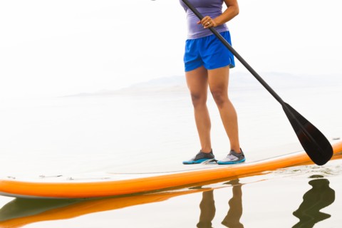 Filipino woman riding paddle board