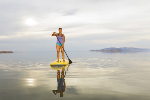 Filipino woman riding paddle board