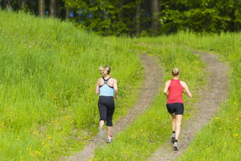 Caucasian women running on path