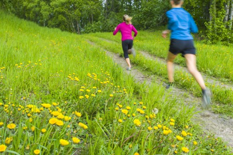 Caucasian women running on path