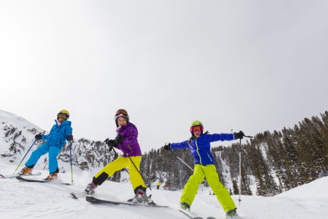 Girls skiing together on snowy slope