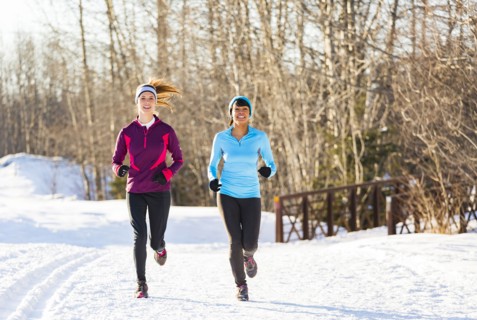 Women running on snow in winter