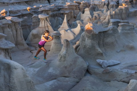 Native American woman stretching in desert