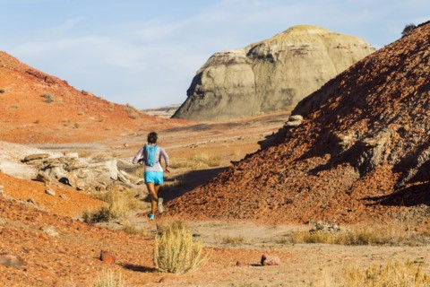 Native American woman running in desert