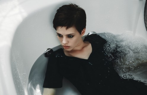 Caucasian woman wearing dress in bathtub