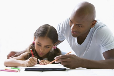 Mixed race father helping daughter with homework