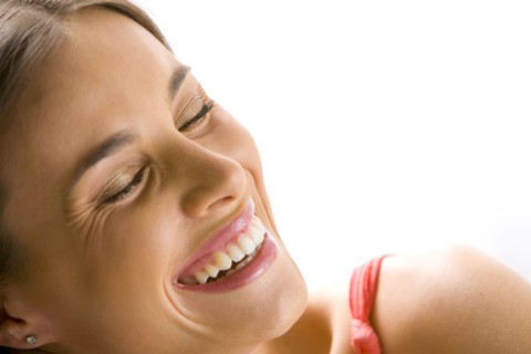 Mixed race woman smiling with eyes closed