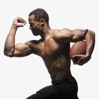 Bare chested football player running with football