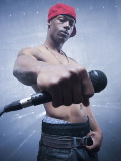 Back lit African singer holding microphone