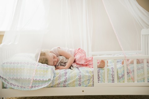 Caucasian girl sleeping in bed