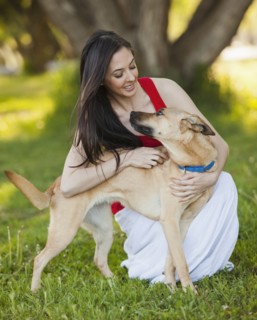 Caucasian woman hugging dog
