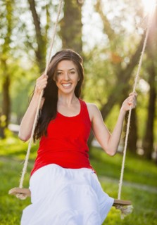 Caucasian woman swinging on swing