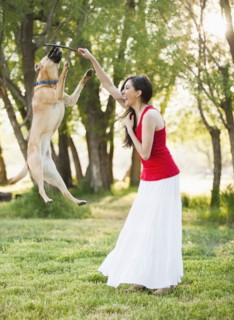 Caucasian woman playing with dog