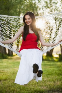 Caucasian woman sitting in hammock