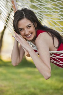 Caucasian woman laying in hammock