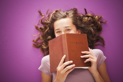 Caucasian teenager holding journal