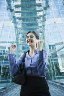 Caucasian businesswoman cheering outdoors