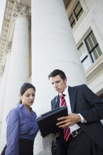 Caucasian business people looking at digital tablet