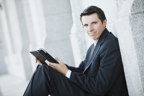 Caucasian businessman using digital tablet outdoors