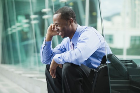 Black businessman talking on cell phone outdoors