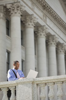 Black businessman using laptop outdoors