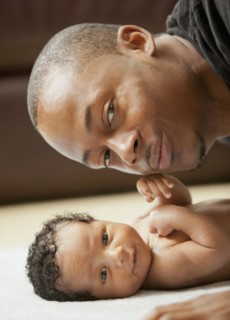Father bonding with newborn baby