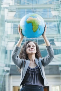 Caucasian businesswoman lifting globe