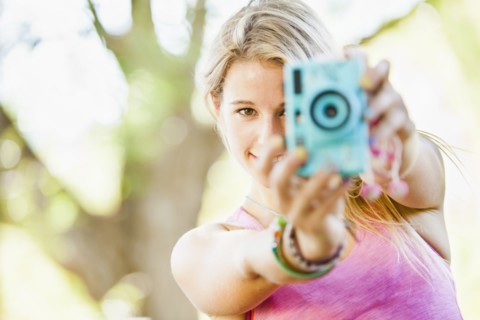 Caucasian woman taking photographs