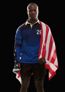 African American rugby player wrapped in American flag