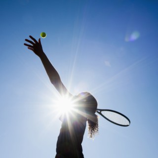 Caucasian woman playing tennis