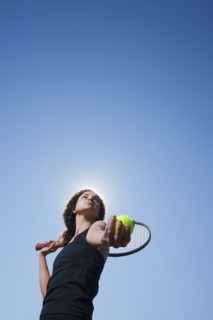Caucasian woman playing tennis