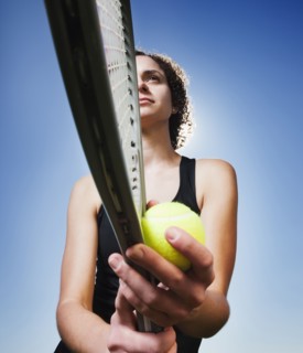 Caucasian woman playing tennis