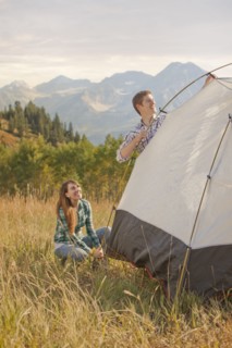 Caucasian couple setting up tent