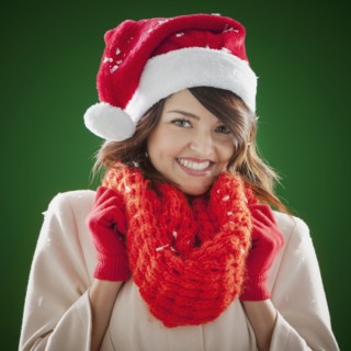 Mixed race woman wearing scarf and Santa hat
