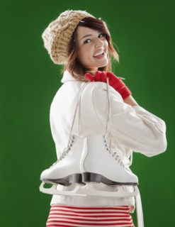 Mixed race woman carrying ice skates