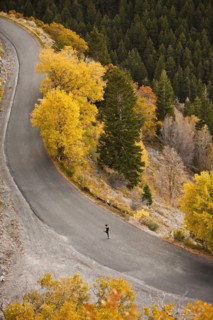 Caucasian woman running along autumn road