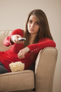 Bored Caucasian woman watching television