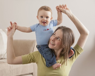 Caucasian mother carrying son on her shoulders