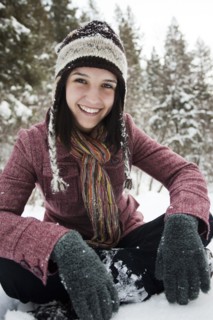 Caucasian woman sitting in the snow