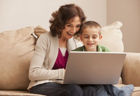 Caucasian grandmother and granddaughter using laptop