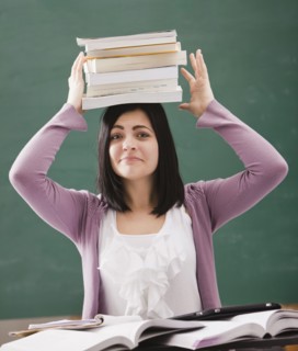 Caucasian student balancing books on head