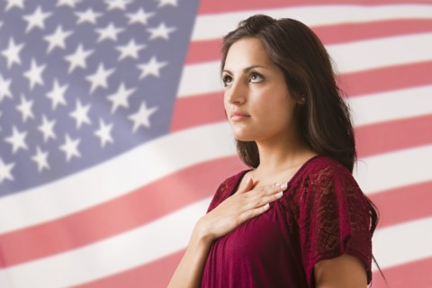 Mixed race woman saluting American flag