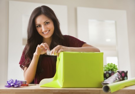 Mixed race woman wrapping gift