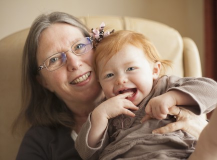 Caucasian grandmother holding granddaughter