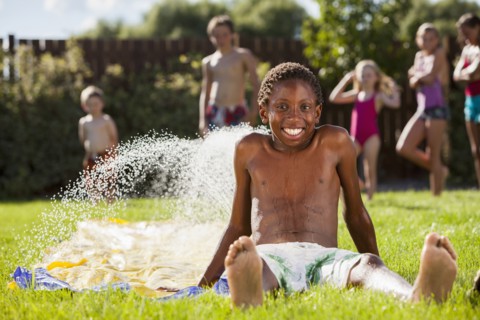 Black boy playing in water