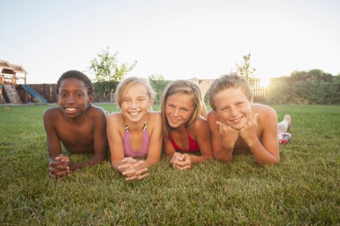 Children laying in the grass together