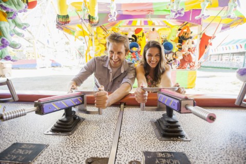 Caucasian couple playing games at carnival