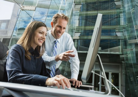Caucasian business people working at computer