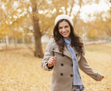 Caucasian woman walking in autumn leaves